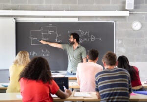 young-male-teacher-giving-a-science-class-presentation-envato